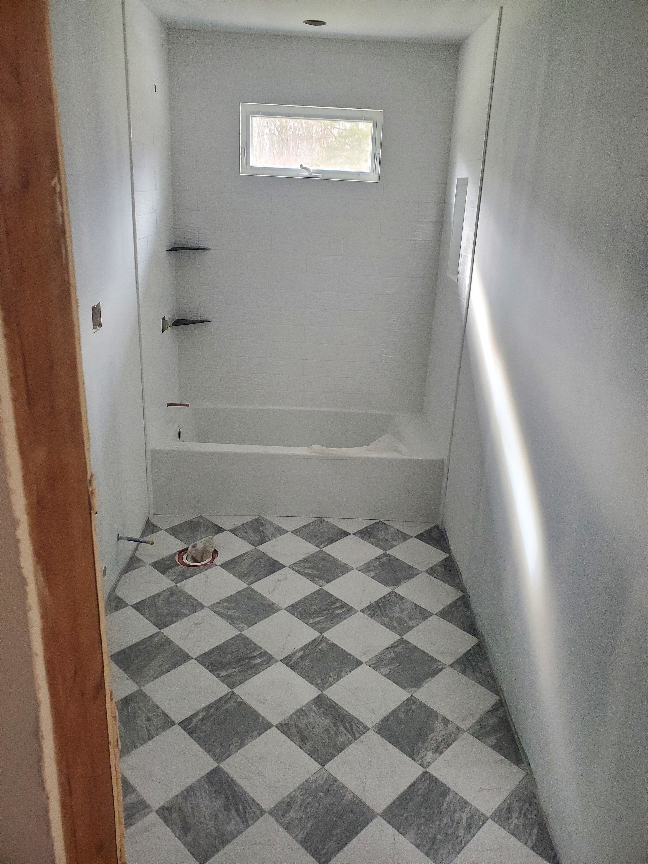 Diamond-pattern marble feature wall, custom geometric tile work