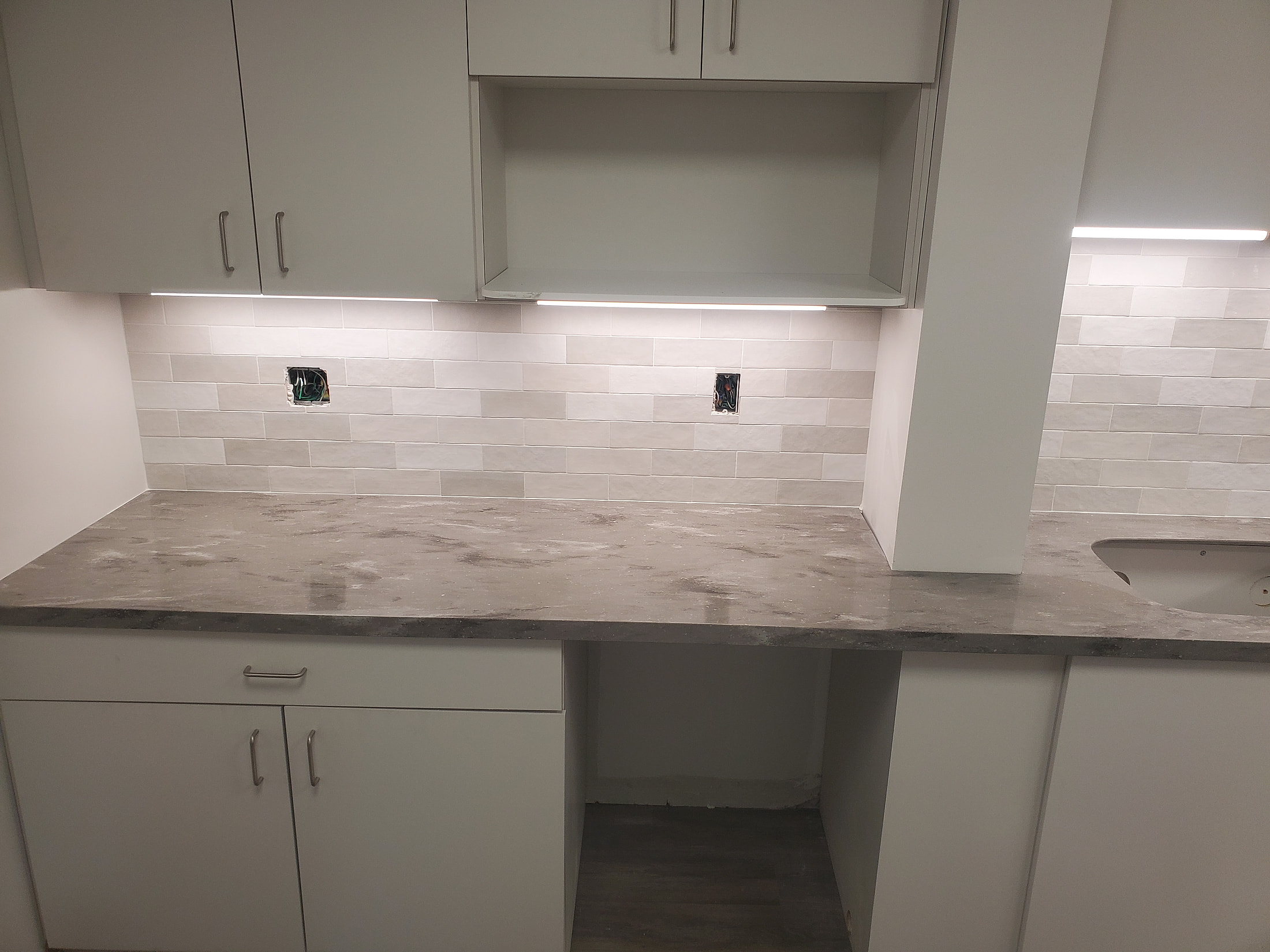 Light gray subway backsplash with marble countertop, butler pantry kitchenette