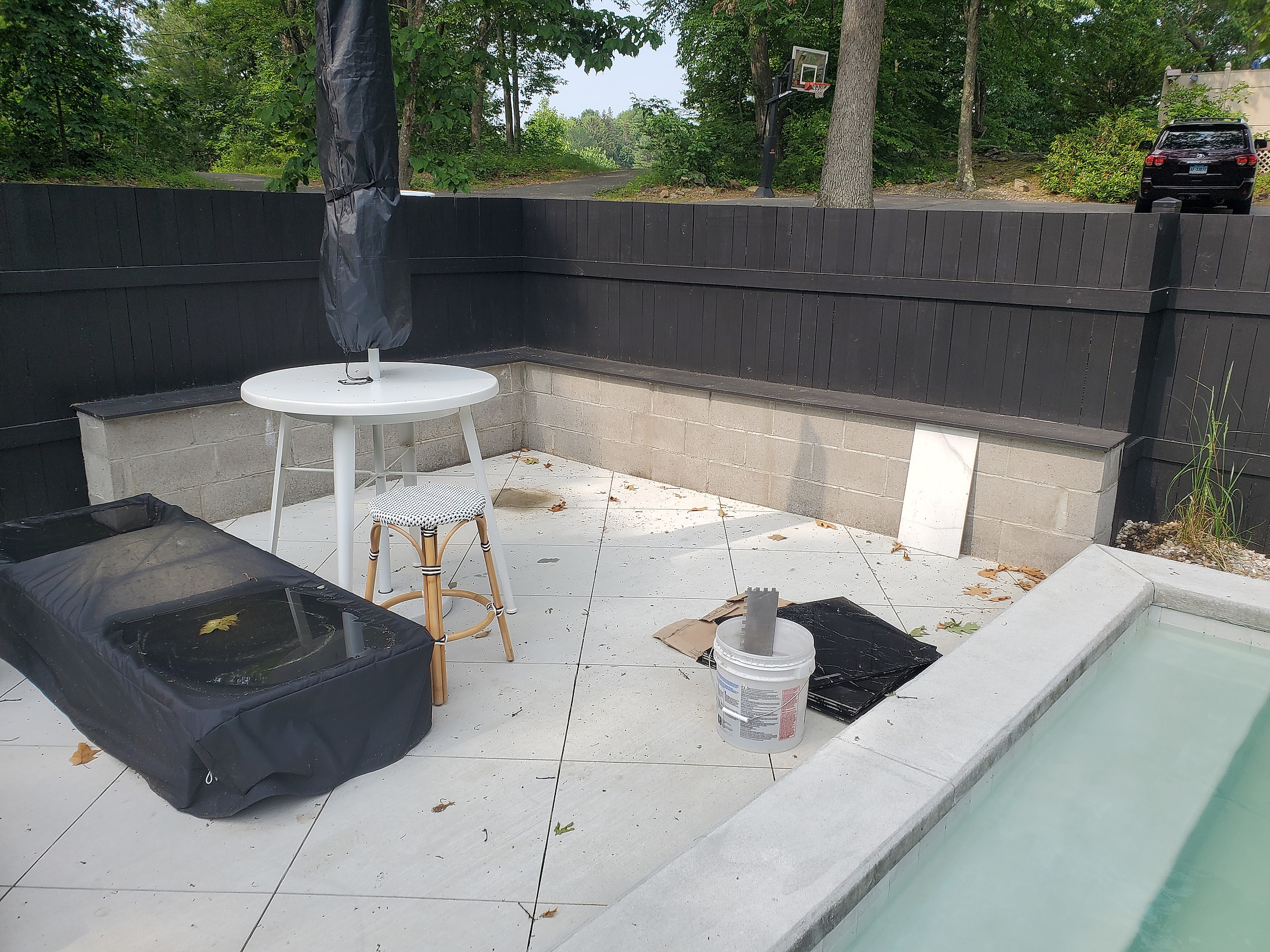 Stone pool deck with custom tile surround, outdoor patio